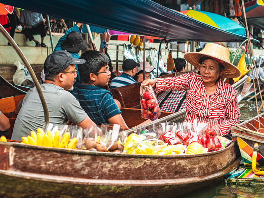 Buying fruits from a fruit vendor in Thailand