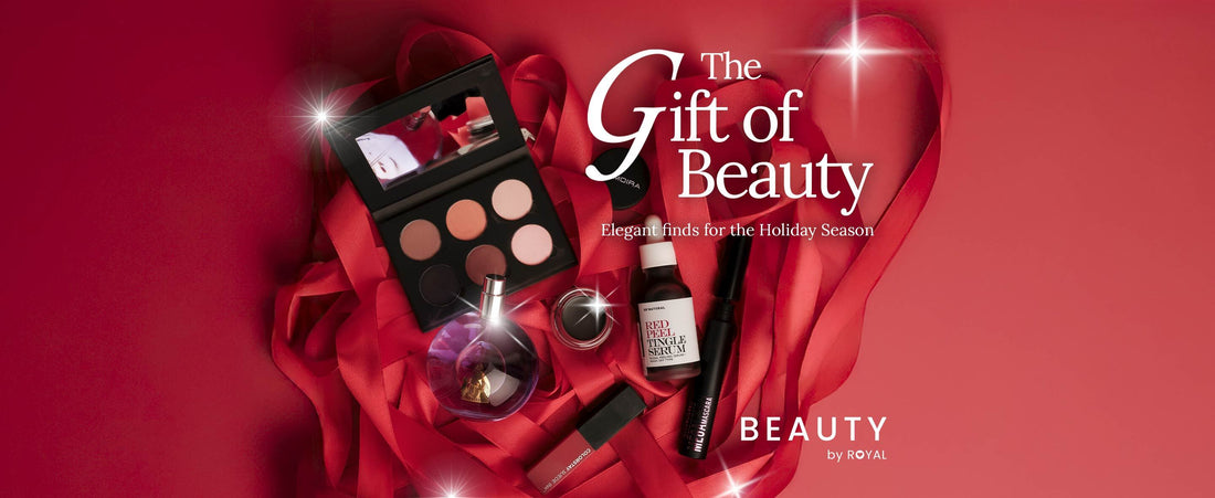 A red banner with red ribbons and make up items in the middle with The Gift of Beauty title. 